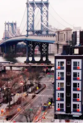 a bridge over a city with a bridge in the background at Madison LES Hotel in New York