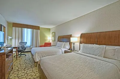 a hotel room with two beds and a desk at Hilton Garden Inn by Hilton Mount Laurel in Mount Laurel