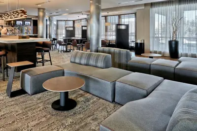 a lobby with couches and tables and a bar at Courtyard by Marriott York in York