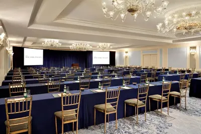 a conference room with blue tables and chairs at Lotte New York Palace in New York
