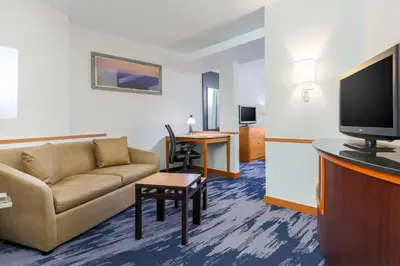 a living room with a couch and a tv at Fairfield Inn & Suites by Marriott Mahwah in Mahwah