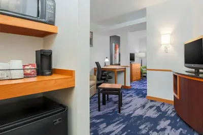 a hotel room with a desk and a tv at Fairfield Inn & Suites by Marriott Mahwah in Mahwah