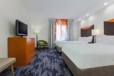 a hotel room with two beds and a flat screen tv at Fairfield Inn & Suites by Marriott Mahwah in Mahwah