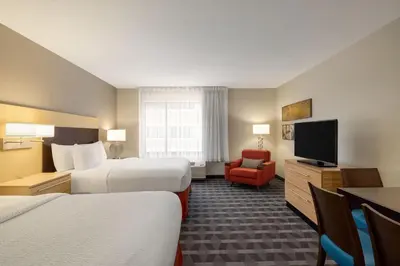 a hotel room with two beds and a television at TownePlace Suites by Marriott Williamsport in Williamsport