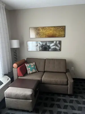 a living room with a couch and a table at TownePlace Suites by Marriott Williamsport in Williamsport
