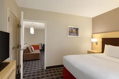 a hotel room with a bed and a couch at TownePlace Suites by Marriott Williamsport in Williamsport