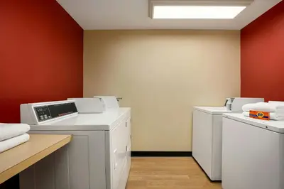 a laundry room with two washer and dryers at TownePlace Suites by Marriott Williamsport in Williamsport