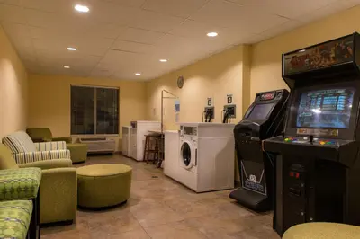 a waiting room with a video game console and a video game at Holiday Inn Express and Suites Dickson City by IHG in Dickson City
