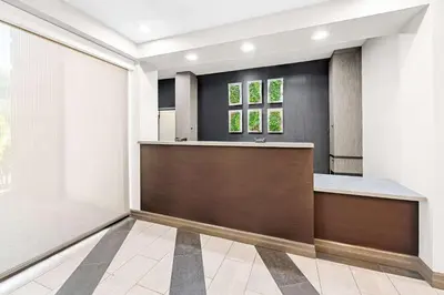 an office lobby with a reception counter and windows at Best Western Inn at Ramsey in Ramsey