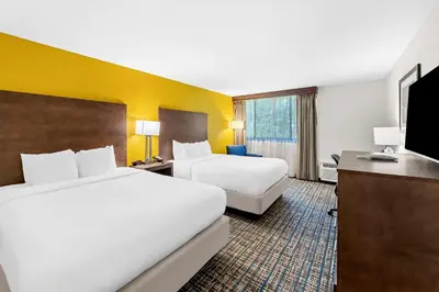 a hotel room with two beds and a flat screen tv at Best Western Inn at Ramsey in Ramsey