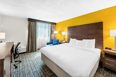 a hotel room with a large bed and a desk at Best Western Inn at Ramsey in Ramsey