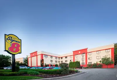 a store with a sign in front of a building at Super 8 by Wyndham Mahwah in Mahwah