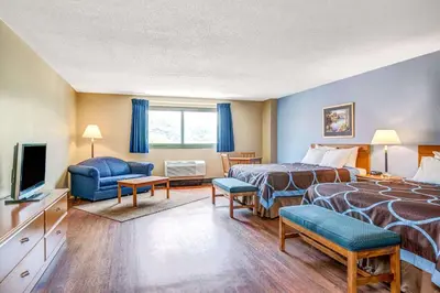 a hotel room with two beds and a television at Super 8 by Wyndham Mahwah in Mahwah