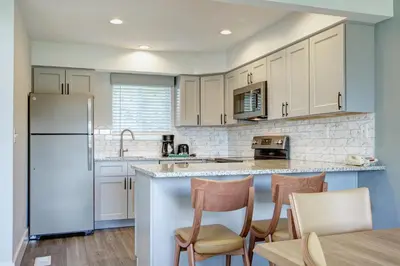 a kitchen with white cabinets and a blue refrigerator at Pocono Mountain Villas MOD Collection by Sonesta in East Stroudsburg
