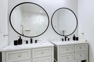 a bathroom with two sinks and two mirrors at Pocono Mountain Villas MOD Collection by Sonesta in East Stroudsburg