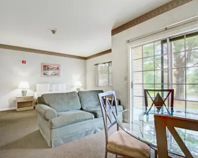 a living room with a couch and a glass table at Pocono Mountain Villas MOD Collection by Sonesta in East Stroudsburg