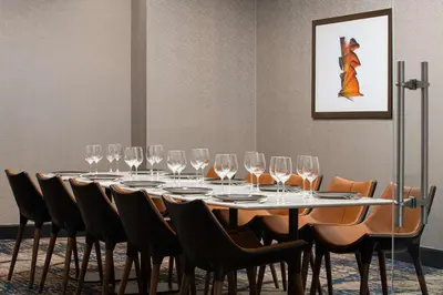 a table with wine glasses on it in a room at The Alloy, a DoubleTree by Hilton - Valley Forge in King of Prussia