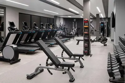 a gym with rows of exercise bikes and treadmills at The Alloy, a DoubleTree by Hilton - Valley Forge in King of Prussia