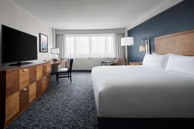 a hotel room with a bed and a flat screen tv at The Alloy, a DoubleTree by Hilton - Valley Forge in King of Prussia