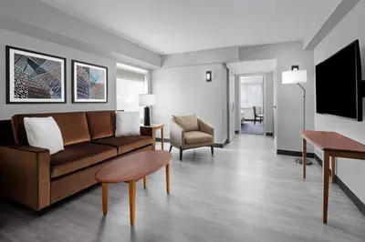 a living room with a couch and a table at The Alloy, a DoubleTree by Hilton - Valley Forge in King of Prussia