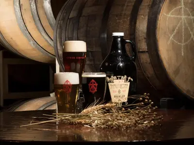 twoints of beer sitting on a table in front of barrels at Shawnee Inn and Golf Resort in East Stroudsburg