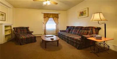 a living room with two couches and a coffee table at Suites on Main in Margaretville