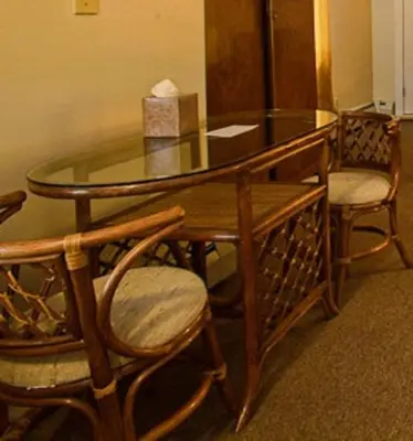a glass table with two chairs and a box on top at Suites on Main in Margaretville