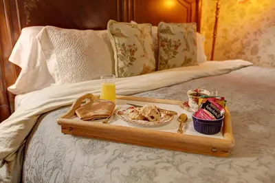 a tray of food on top of a bed at Margaretville Mountain Inn B&B in Margaretville