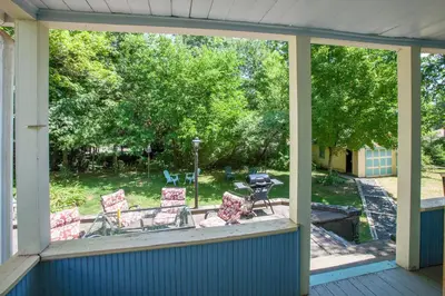 a screened in porch with a view of a yard at Village Suites in Margaretville