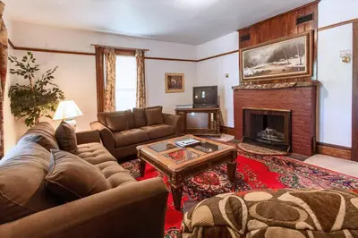 a living room with a couch and a fireplace at Village Suites in Margaretville
