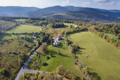 an aerial view of a house in a field at Village Suites in Margaretville