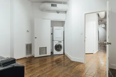 a laundry room with a washer and dryer in it at The Havana Lofts in Philadelphia