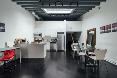 a kitchen and dining room with a table and chairs at The Havana Lofts in Philadelphia