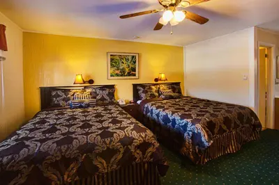 a hotel room with two beds and a ceiling fan at Margaretville Motel in Margaretville