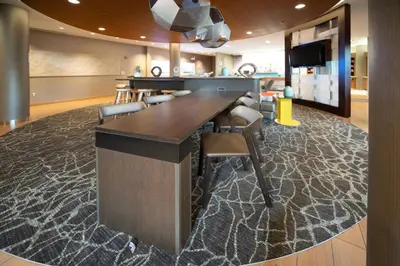 a lobby with a bar with chairs and a television at SpringHill Suites by Marriott Philadelphia Valley Forge/King of Prussia in King of Prussia