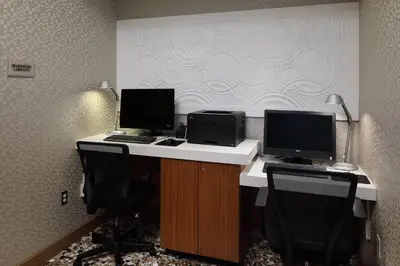 an office with two monitors and two computers on a desk at SpringHill Suites by Marriott Philadelphia Valley Forge/King of Prussia in King of Prussia
