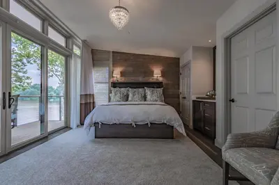 a bedroom with a bed and a large window at Carriage House New Hope in New Hope