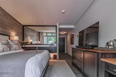 a bedroom with a large bed and a large mirror at Carriage House New Hope in New Hope
