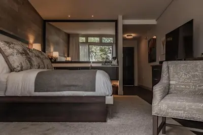 a bedroom with a large bed and a chair at Carriage House New Hope in New Hope