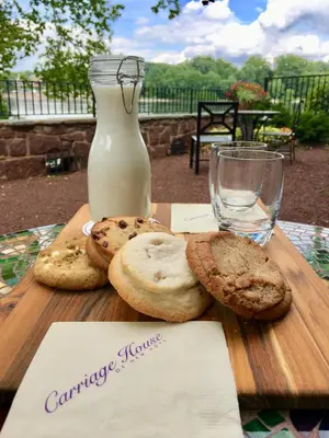 a wooden table with cookies and a bottle of milk at Carriage House New Hope in New Hope