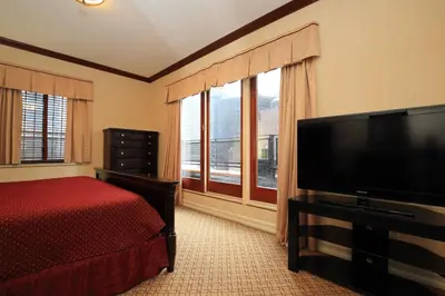 a bedroom with a bed and a flat screen tv at Radio City Apartments in New York