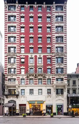 a large red building on a city street at Radio City Apartments in New York