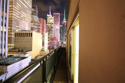 a view of a city skyline from a balcony of a building at Radio City Apartments in New York