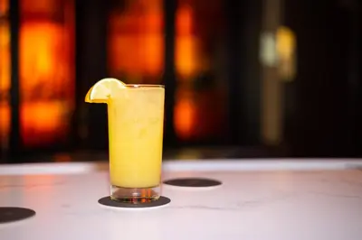 a glass of orange juice sitting on a table at Courtyard Philadelphia Coatesville Exton in Coatesville