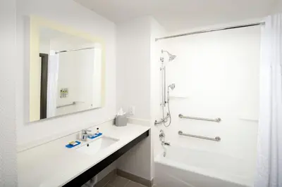 a white bathroom with a sink and a shower at Holiday Inn Express & Suites - North Brunswick by IHG in North Brunswick