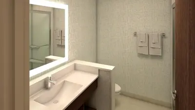 a bathroom with a sink and a toilet and a mirror at Holiday Inn Express & Suites - North Brunswick by IHG in North Brunswick