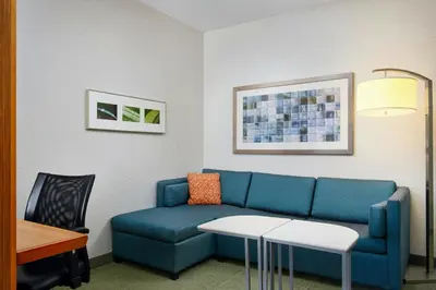 a living room with a blue couch and a table at SpringHill Suites by Marriott Scranton Montage Mountain in Moosic