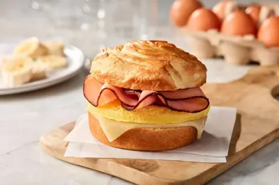 a sandwich with meat and cheese on a bun on a cutting board at SpringHill Suites by Marriott Scranton Montage Mountain in Moosic