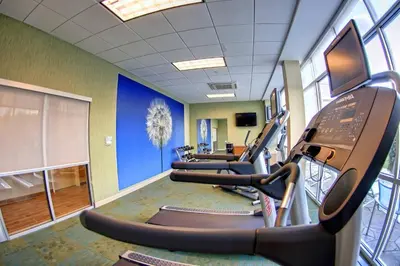 a gym with treadmills and a row of treadleys at SpringHill Suites by Marriott Scranton Montage Mountain in Moosic