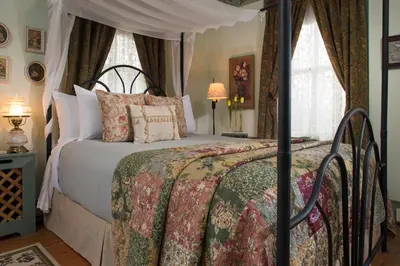 a bedroom with a bed with a canopy at 1825 Inn Bed and Breakfast in Palmyra